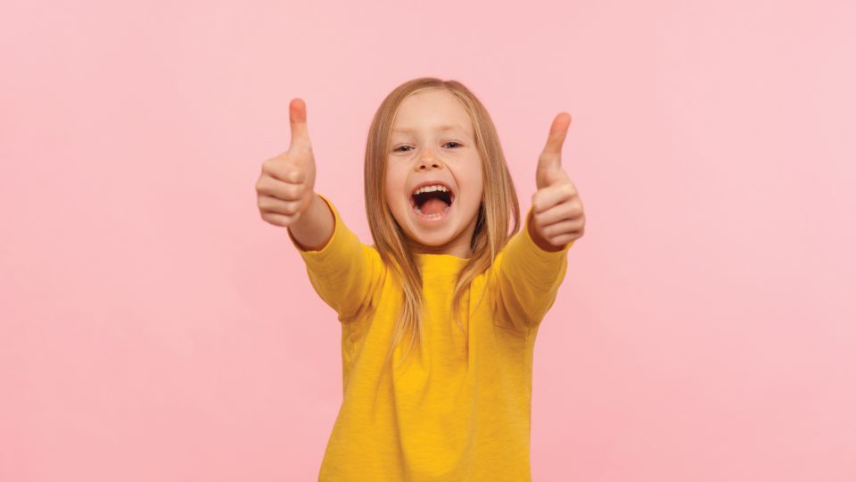 Happy child with thumbs-up
